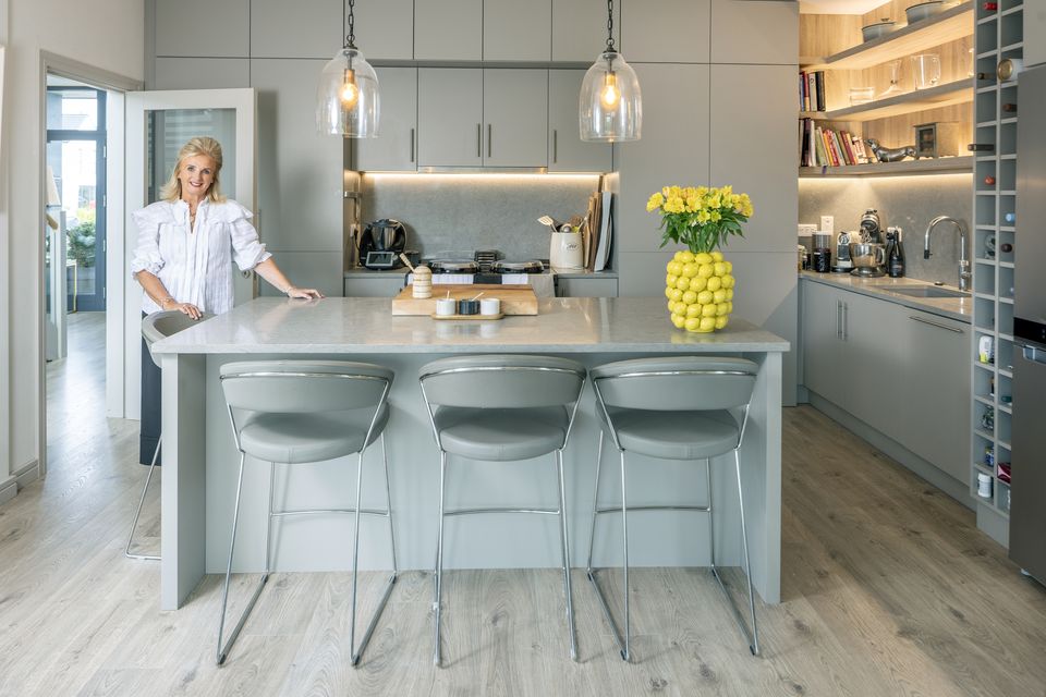 Fashion aficionado Sandra Walsh in the kitchen of her lovely home in Baltray, Co Louth. The floors are oak laminate and the kitchen units were made by Fred Gough who did all the joinery in the house. The lemon vase from Little Strand Antiques is one of her favourite things. Photo: Tony Gavin